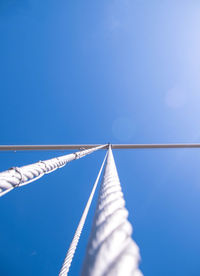 Low angle view of rope against clear blue sky