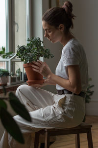 Woman sitting on chair at home