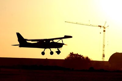 Silhouette airplane against clear sky