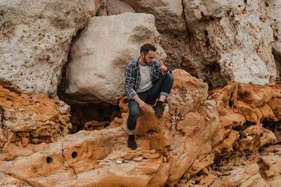 Full length of man standing on rock