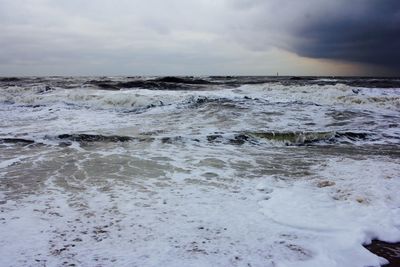 Scenic view of sea against cloudy sky