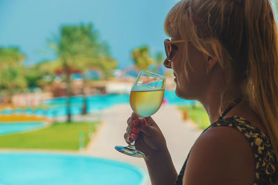 Portrait of woman drinking water in swimming pool