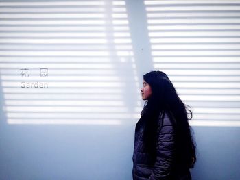 Woman standing against the wall