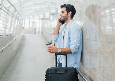 Side view of young woman using mobile phone