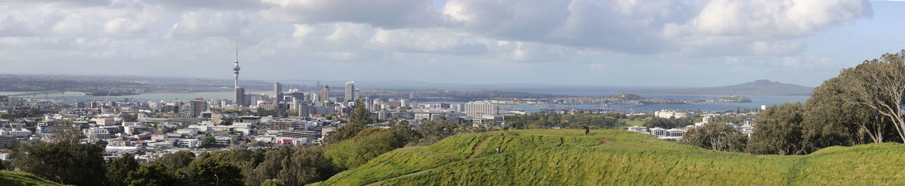 Panoramic view of city against cloudy sky