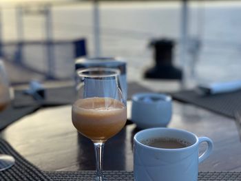 Close-up of coffee served on table at outdoor cafe during sunset