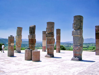 View of wooden posts against clear blue sky