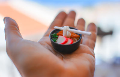 Close-up of person holding fruit
