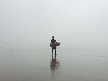 Silhouette of woman in sea
