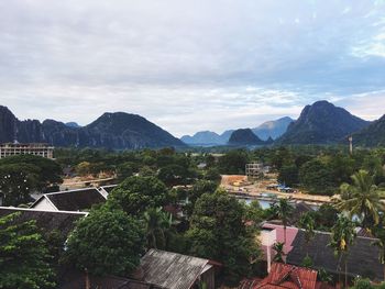 Town by mountains against sky