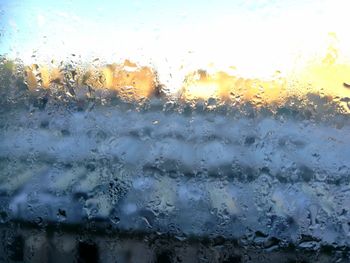 Full frame shot of wet glass window during rainy season