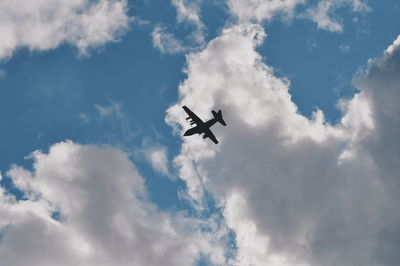 Low angle view of airplane flying in sky