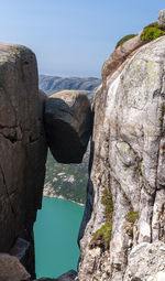 Rock formations by sea against sky