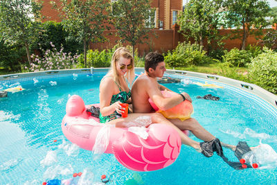 Woman sitting in swimming pool