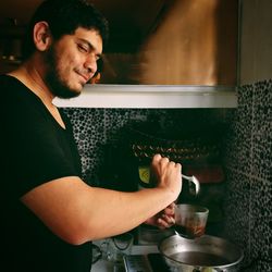 Young man preparing food at home