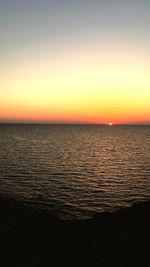 Scenic view of sea against clear sky during sunset