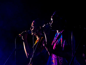 Two women singing on stage