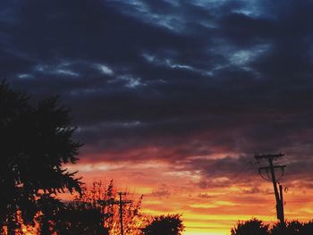 Low angle view of silhouette trees against sky during sunset