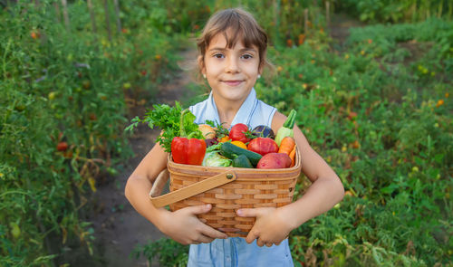 Portrait of young woman picking apples