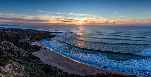 Scenic view of sea against sky at sunset