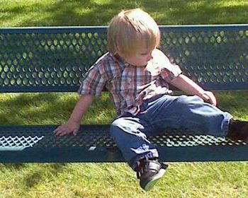 Girl sitting on grassy field in park