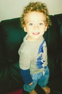 Portrait of smiling boy standing at home