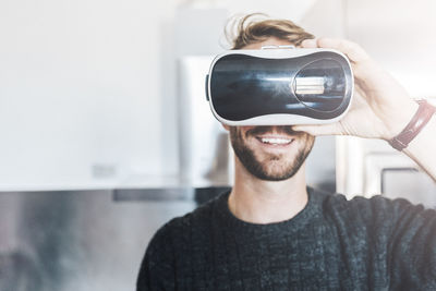 Smiling man wearing virtual reality glasses