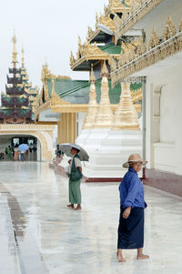 People walking in temple outside building