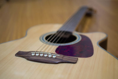 Close-up of guitar on table