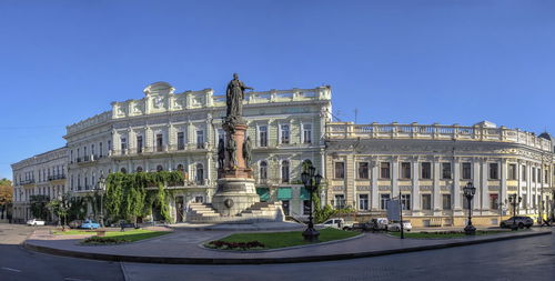 Low angle view of historical building against clear blue sky