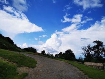 Empty road along countryside landscape