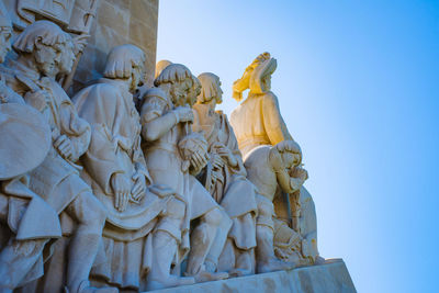 Low angle view of statue against clear blue sky