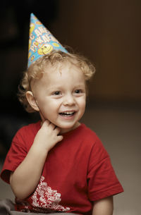 Cheerful cute boy wearing party hat