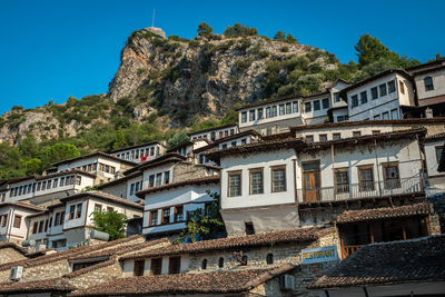 Low angle view of buildings in town against sky