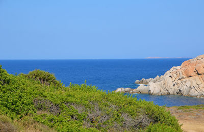 Scenic view of sea against clear blue sky