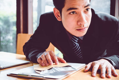 Portrait of young man sitting at table