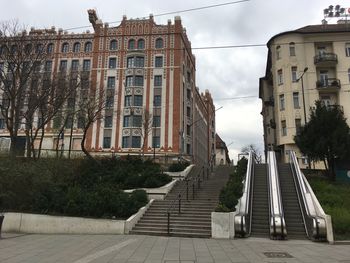 Street amidst buildings against sky in city