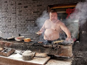 Young man in front of smoke