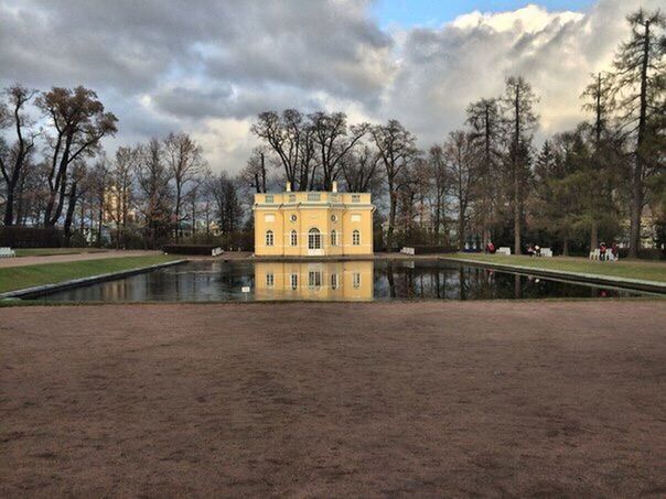 tree, sky, architecture, built structure, cloud - sky, building exterior, cloudy, cloud, park - man made space, bare tree, water, nature, day, fountain, incidental people, travel destinations, outdoors, pond, city, growth