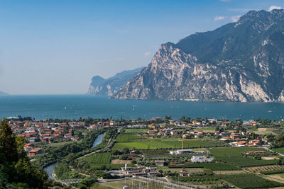 High angle view of townscape by sea against sky