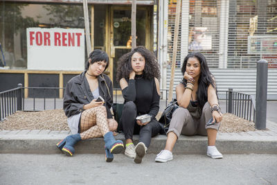 Friends outside a grocery store in queens, new york