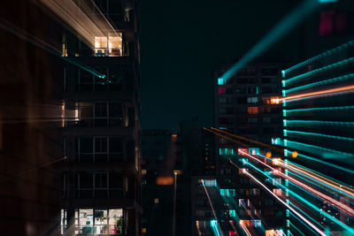 Blurred motion of illuminated street and buildings at night