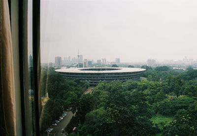 Stadium seen through window against clear sky