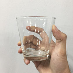 Close-up of hand holding drinking glass