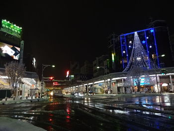 Illuminated city street at night