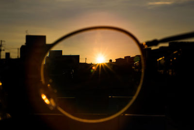 Close-up of silhouette city against sky during sunset