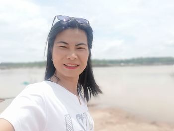 Portrait of smiling young woman on beach