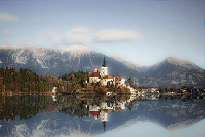 View of lake bled with snowcapped mountain in background