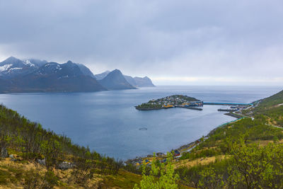 Scenic view of sea and mountains against sky