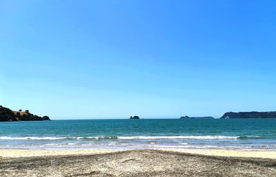 Scenic view of sea against clear blue sky